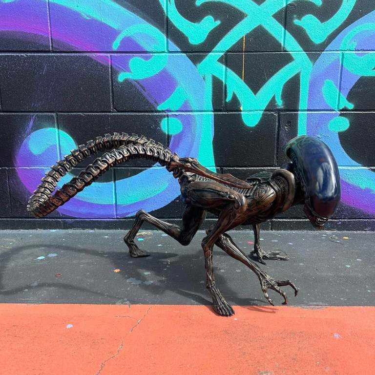 Bronze-finish 3D printed xenomorph crawling pose, side view